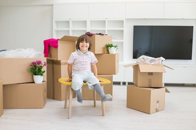 Happy kids with boxes at new modern home