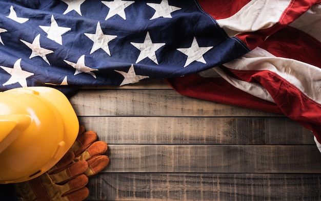 Happy Labor day concept American flag with different construction tools on dark wooden background