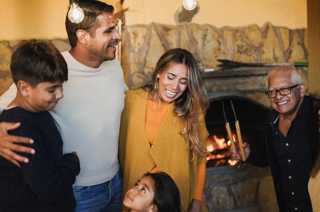 Happy latin family enjoy barbecue lunch together at home patio