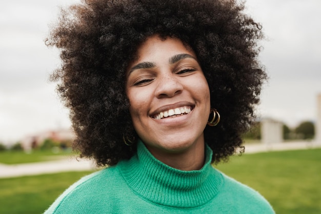 Happy latin woman smiling on camera outdoor