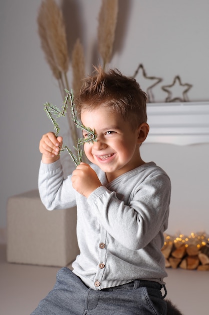 Happy little boy playing with Christmas decoration. Smiling child, celebration, Xmas time.