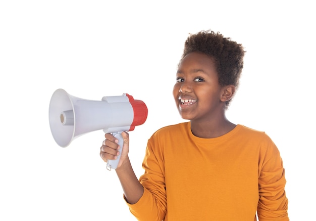 Happy little child speaking with a megaphone isolated on a white wall