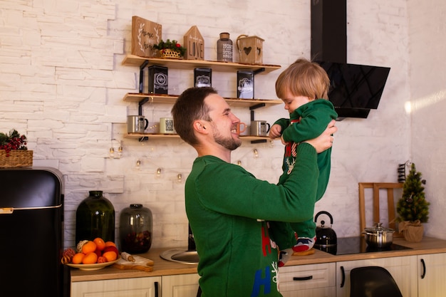 Happy little child with father in kitchen at home