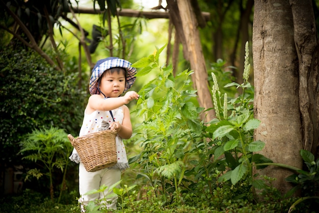 Happy little cute girl in the garden