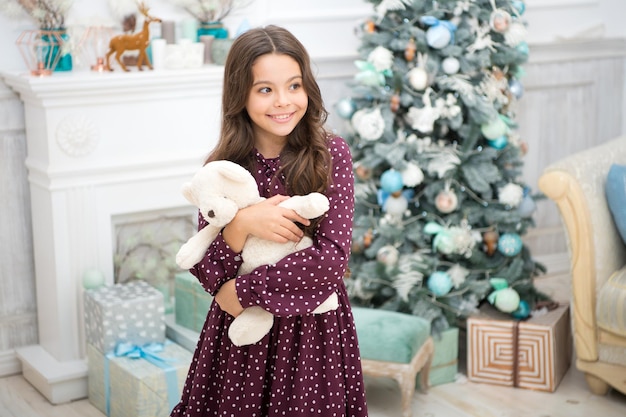 Happy little girl celebrate winter holiday happy new year christmas time The whole world in one touch Cute little child girl with xmas present delivery christmas gifts Capturing happy moments