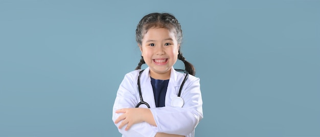 Happy little girl  in doctor coat with stethoscope. Child playing. Future occupation or dream job concept. Happy children's day.