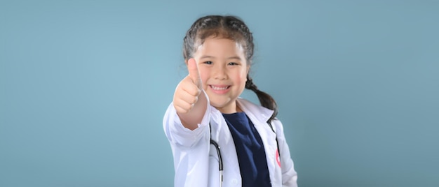 Happy little girl  in doctor coat with stethoscope. Child playing. Future occupation or dream job concept. Happy children's day.