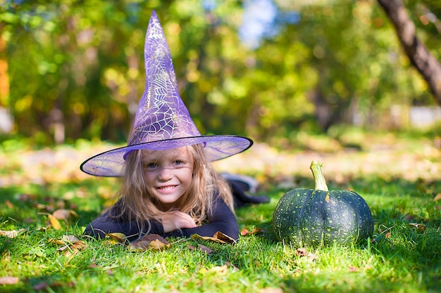 Happy little girl in halloween costume with jack pumpkin.Trick or treat