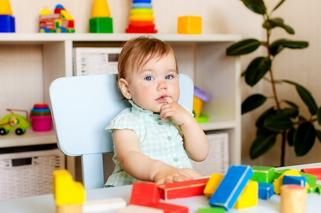 Happy little girl playing with toys at home