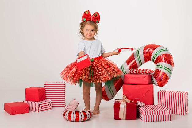 Happy  little girl surrounded by christmas elements