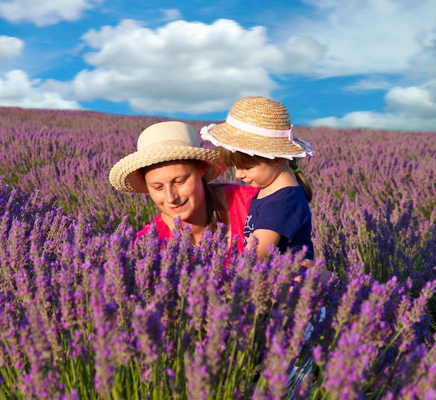 Happy little girl with her mother are in a lavender field