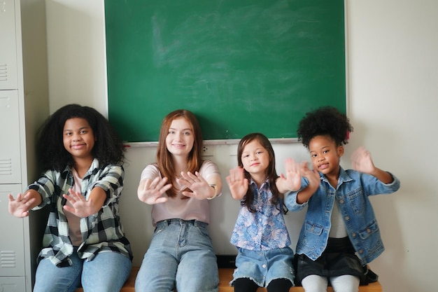 Happy little Girls against Chalkboard With Back To School