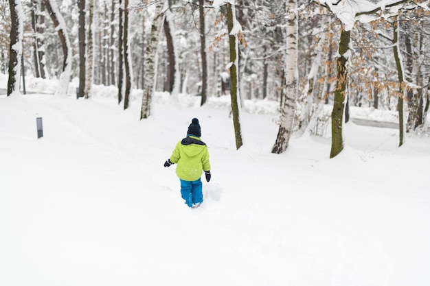 Happy Little Kid is Playing in Snow