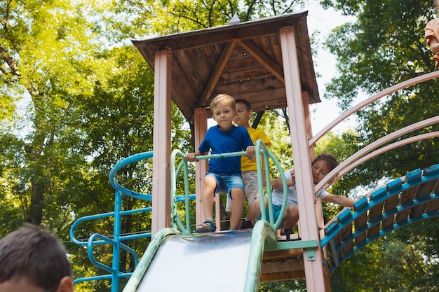 The happy little kids about to slide in the playground