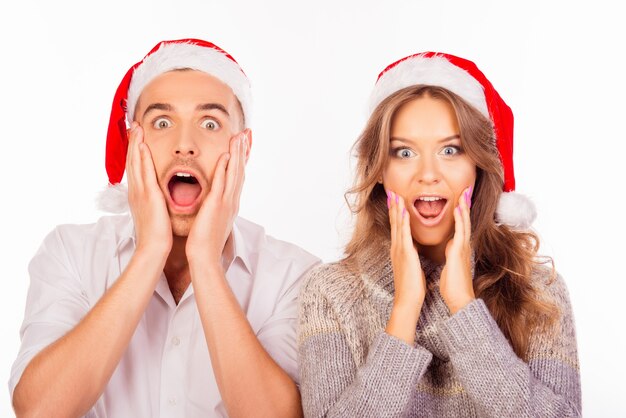 Happy loving couple with Santa hats