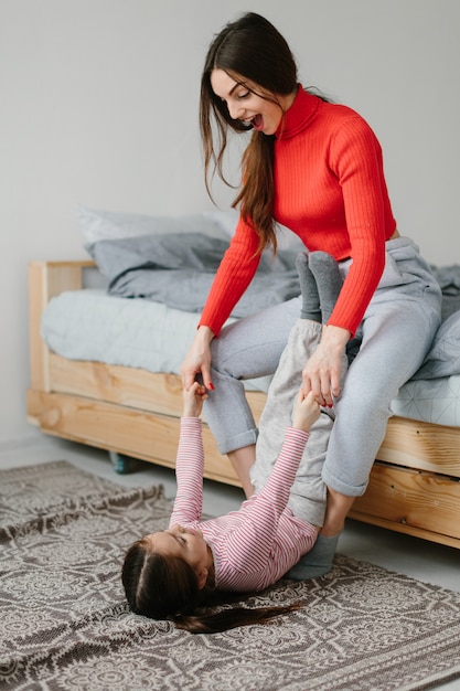 Happy loving family. Mother and her daughter child girl playing and hugging.