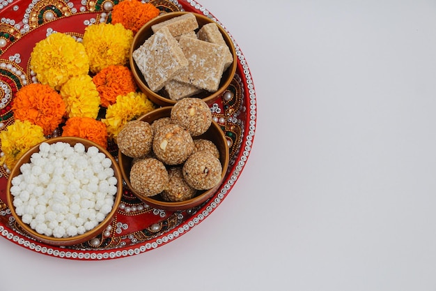 Happy Makar Sankranti, Pongal and Uttarayan with Kite, haldi kum kum bowls and tilgul sweets