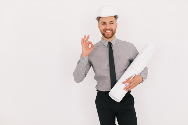 Photo happy male chief architect holding drawing with copy space on a white background