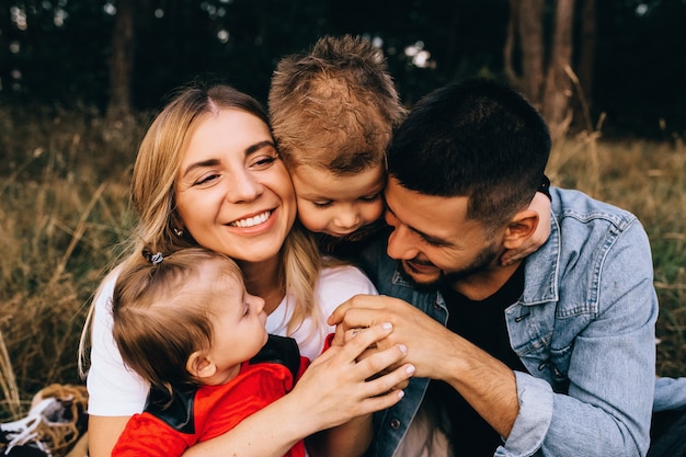 Happy male and female playing with children outside