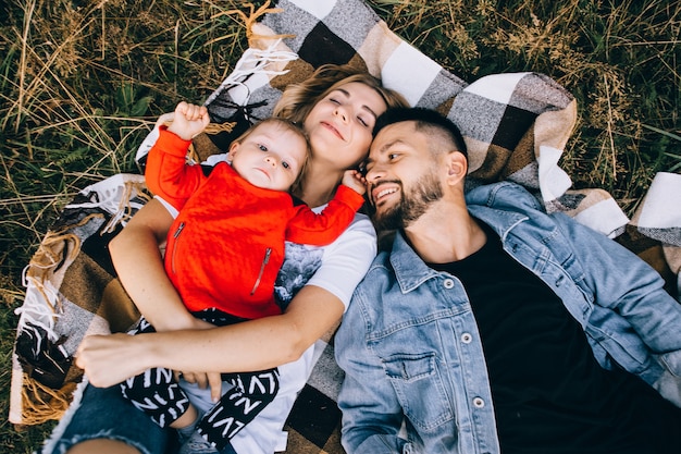 Happy male and female playing with children outside