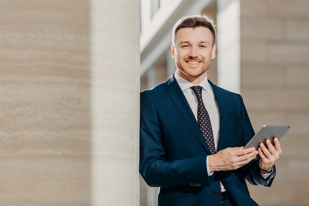 happy male manager dressed in black formal suit