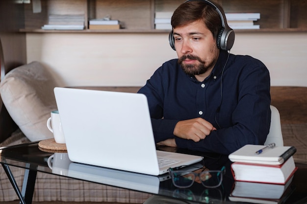 Happy male student online teacher wear headphone talk video calling