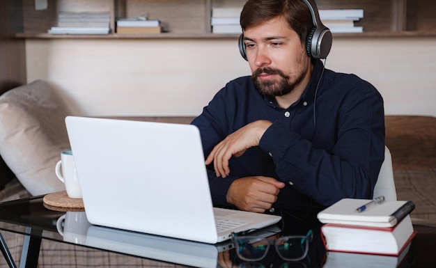 Happy male student online teacher wear headphone talk video calling