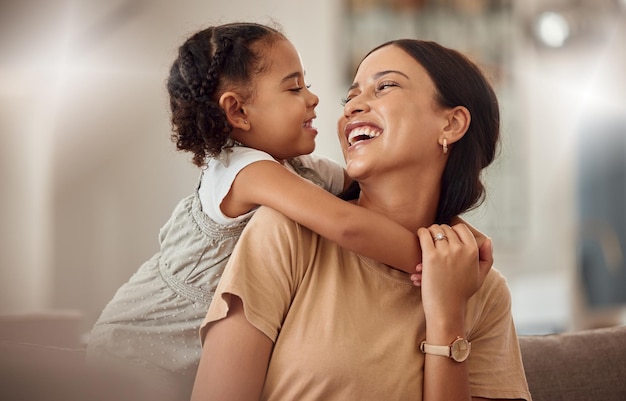 Happy mama with girl child hug in home and weekend play time lifestyle for mom parent Funny crazy kid in living room mother holding toddler with smile and love bonding together on mothers day