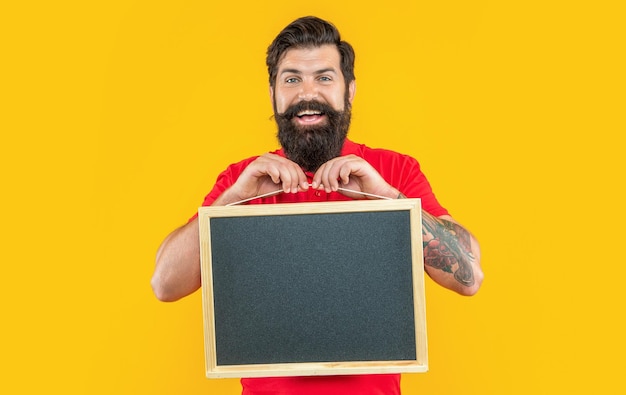 Happy man advertising here in studio man advertising here on background