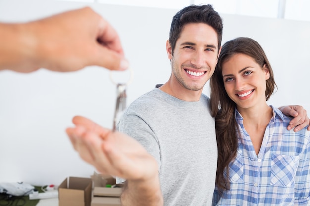 Happy man being given a house key