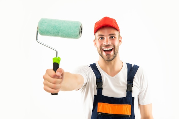 Happy man in builder uniform hold paint roller isolated on white background decorator