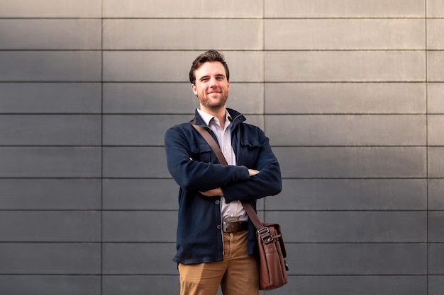 Happy man entrepreneur with arms folded