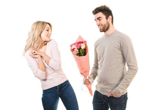 The happy man giving flowers for a girlfriend on the white background