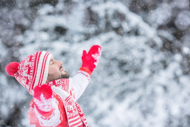 Happy man having fun in winter park