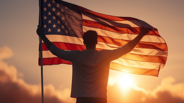 Happy man holding American Flag in the sunset sky freedom and patriotism concept