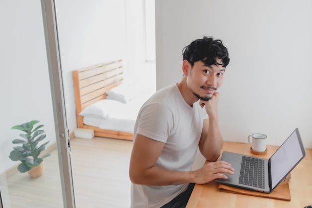 Happy man is working in his apartment concept of work from home