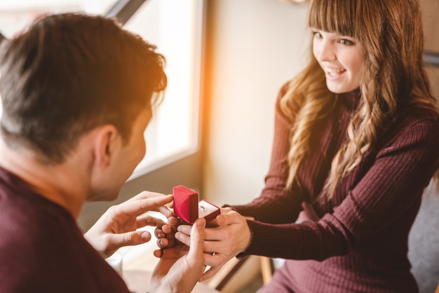 The happy man makes an offer to his girlfriend in the restaurant