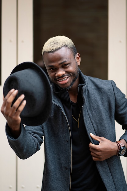 Happy man posing with hat