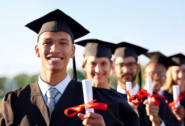 Happy man scholar and graduation class with group at ceremony for education qualification or future Portrait of person or student with smile for diploma certificate or study degree on campus