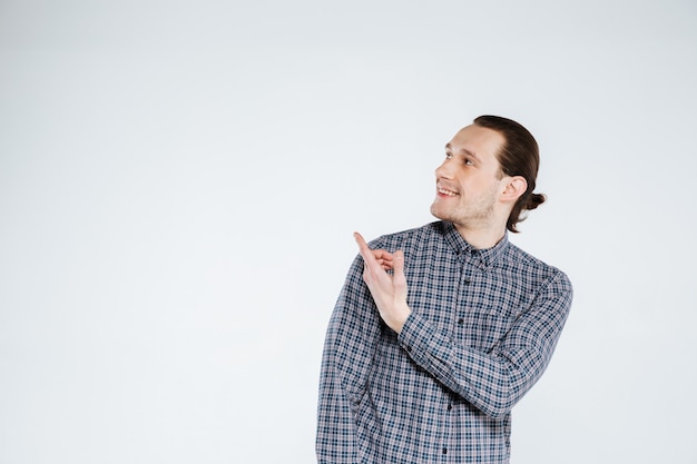 Happy man in shirt pointing away