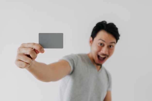 Happy man showing close up empty card