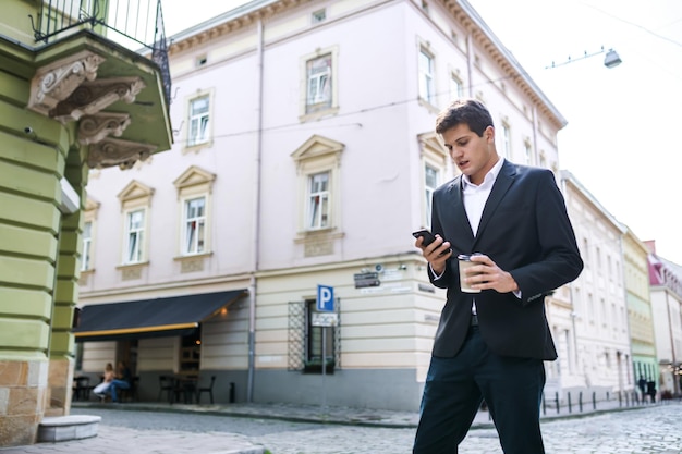 Happy man in a suit and shirt smiling talking on the phone on th