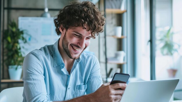 Happy man using a smartphone during his work in the office