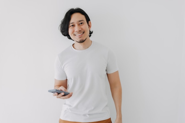 Happy man using smartphone on white background and copy space