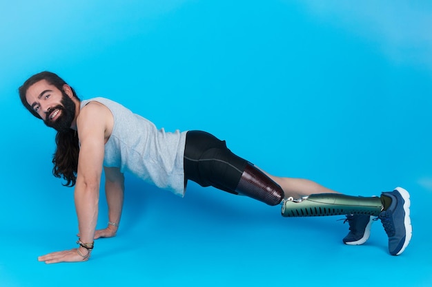 Happy man with a prosthetic leg doing push ups