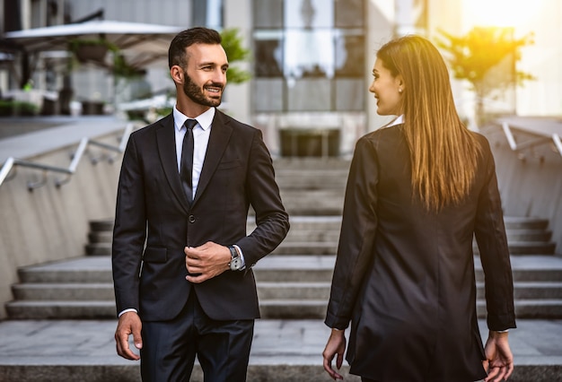 The happy man and woman walking in the business center