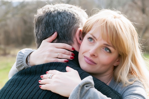 Happy mature couple embracing and hugging outdoors 