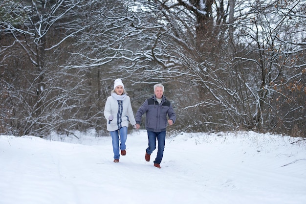 Happy mature couple have fun outdoors in winter