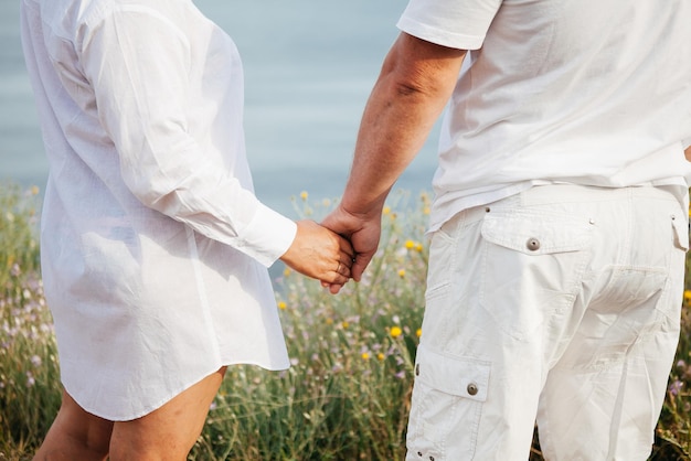 Happy mature couple pose on sunny day on the beach