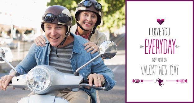 Happy mature couple riding a scooter in the city against valentines day greeting